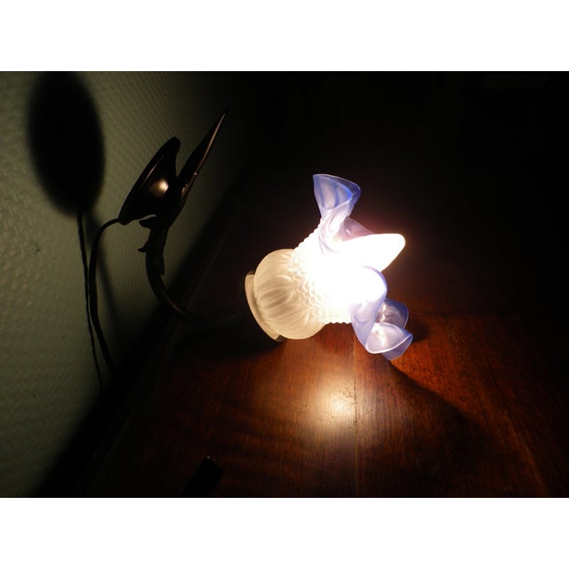 Two wall sconces with corolla-shaped opaline glass shades. The shades are opaque white with a blue gradient rim and...