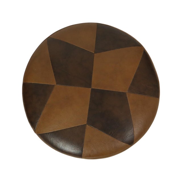 Cool vintage round pouf in patchwork style, made from a wooden base and upholstered in high-quality two-tone brown faux...