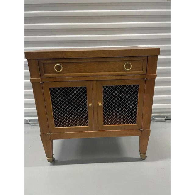 Offered is a vintage nightstand by Milling Road for Baker Furniture. This piece features one dovetailed smooth gliding...