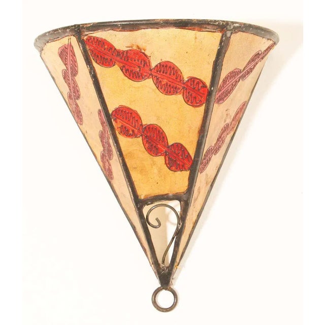 African tribal art parchment wall shade sconce featuring a large triangle hide form stitched on iron and hand painted...
