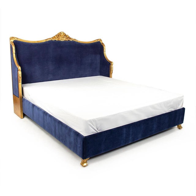 The Georgia Queen Bed from Zentique is a French Louis XV-style queen bed in navy blue velvet with a carved gold-leafed...