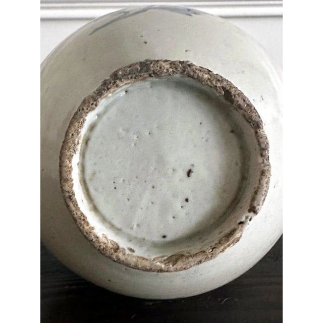 A Korean white porcelain jar with underglaze blue painting of large peonies with leaves circa second half of 19th century,...