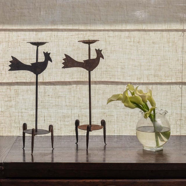 Lovely pair of iron rooster candlesticks from France, 1950s. Forged iron rooster motif with stem resting on a tripod base....