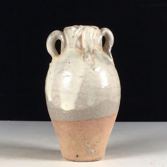 This is a charming vintage folk pottery jar, crafted from earthenware with a rustic, hand-thrown character. The vessel...