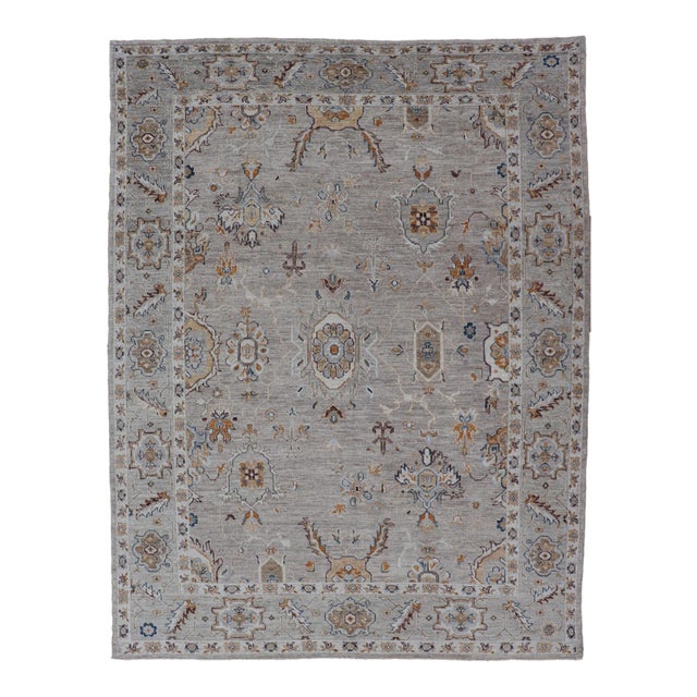 Turkish Angora Oushak Rug With Light Gray Field and Warm Earth Tone Accents For Sale