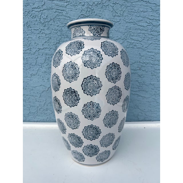 Vintage pair of Tall flower vase featuring a blue pad print medallion pattern. Measures 16” tall with a 9.5” diameter at...