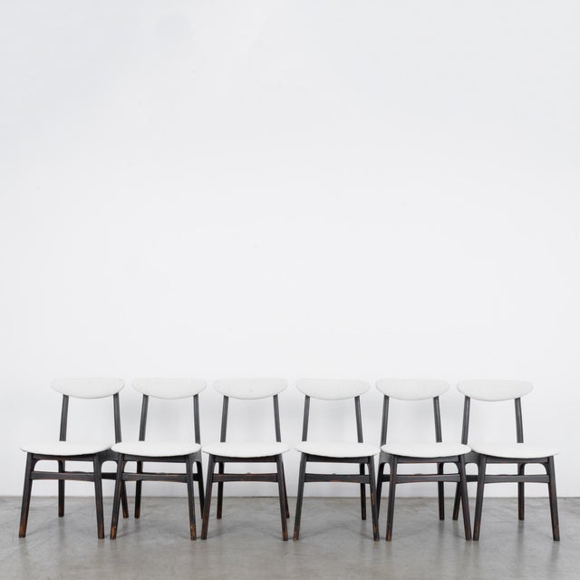 This set of six wooden chairs was made in Poland, circa 1960. The textured white upholstered seat and crescent-shaped back...