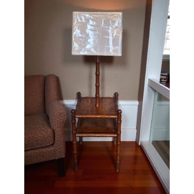 This product is a stylish and elegant floor lamp with a unique design featuring faux bamboo fruitwood burlwood in a...