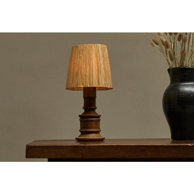 Mid Century Accent Table Lamp in Solid Oak and Patinated Brass with Raffia Shade. A lovely turned solid oak table lamp...