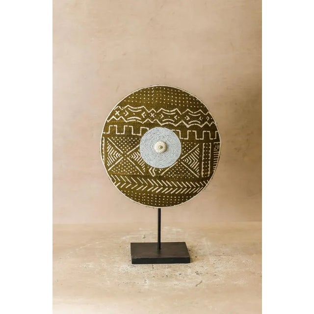 Historically used as a defensive weapon in wartime and displayed as a decorative symbol of status and wealth by the Tikar...