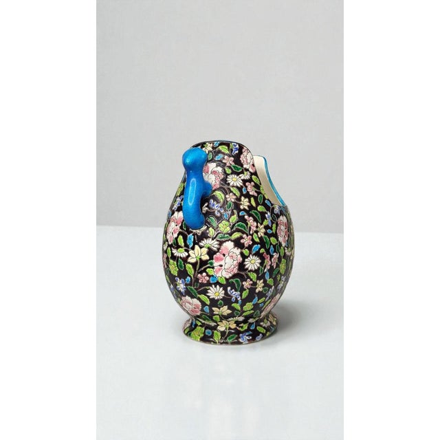 "Gueulard" vase in glazed ceramic from Gien / Handles in the shape of Fô dogs. Black background decorated with flowers....