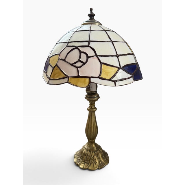 Striking vintage 1998 Tiffany-style table lamp featuring a luminous faux stained-glass mosaic shade in rich cobalt blue,...