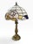 Striking vintage 1998 Tiffany-style table lamp featuring a luminous faux stained-glass mosaic shade in rich cobalt blue,...