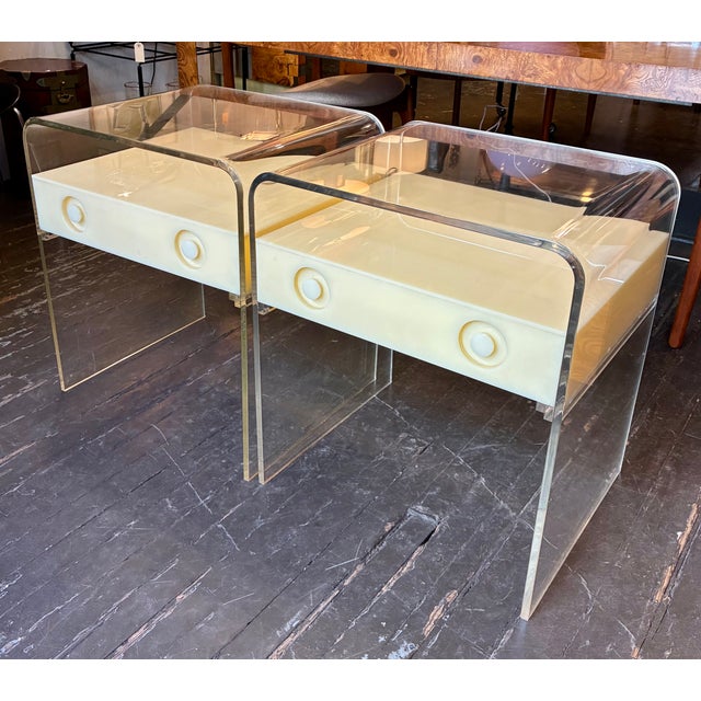 Two Toned Lucite Nightstands from the 1970s with a shelf and a single drawer. A striking design which we have not been...