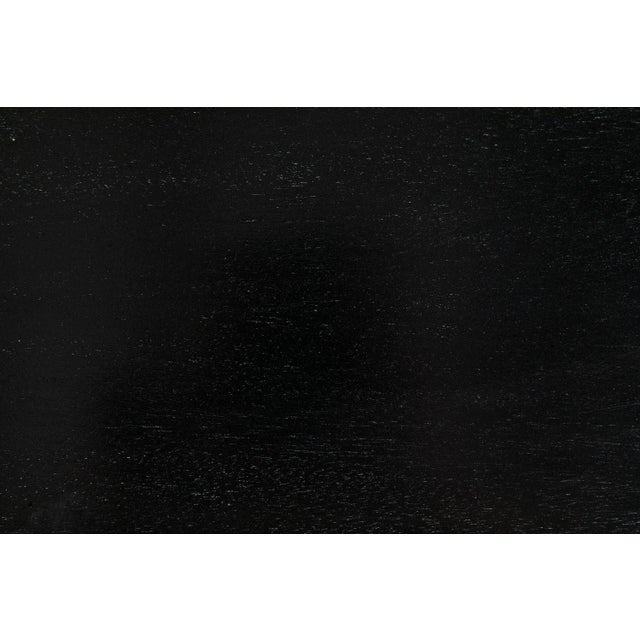 The Drop Coffee Table playfully exudes mood and motion with carved mahogany droplet legs. Comes in black finish with a...