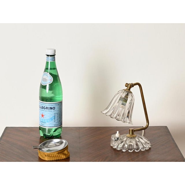 Gorgeous and unique adjustable table lamp crafted in a stunning combination of murano mouth-blown glass and brass. This...