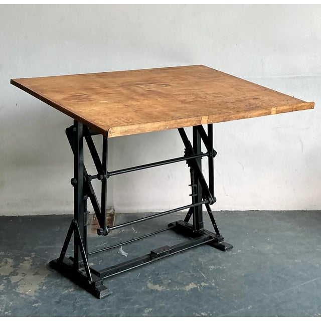 Discover this exceptional vintage industrial drafting desk, a robust and aesthetically compelling piece that marries form...