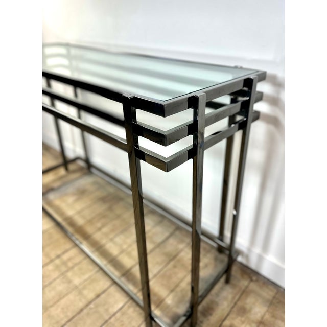Smoked silver metal console table with a glass top, circa 1990s/2000s. Contemporary design that complements any style....