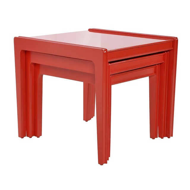 Red lacquered wooden low lacquered tables. This piece is designed in the style of the selected designer and/or manufacturer