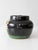 A vintage hand-painted pottery vessel with a glossy black glaze, colorful garden flowers and bold green banding. The...