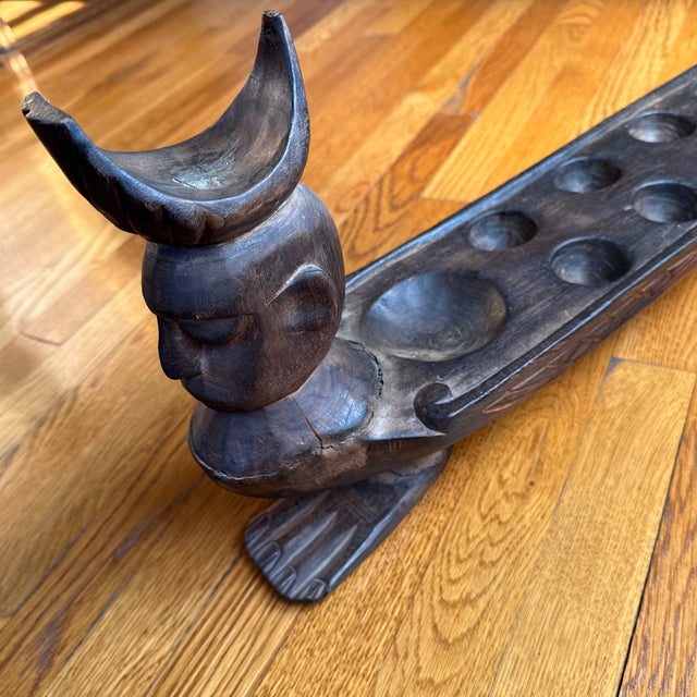 This item is a vintage, hand-carved wooden Mancala sculpture. This ornate carved sculpture is traditional "count-and-...