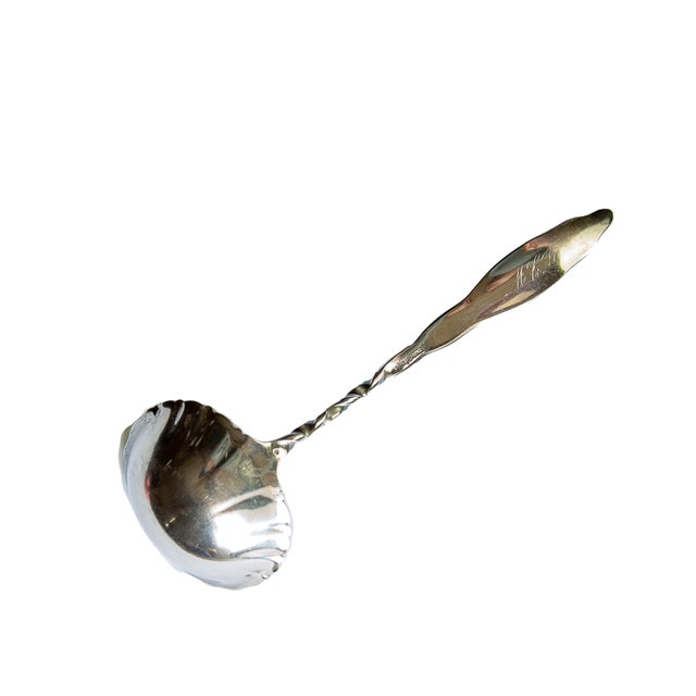 This sterling silver ladle from the Whiting Manufacturing Company is unique for the combination of two different patterns...