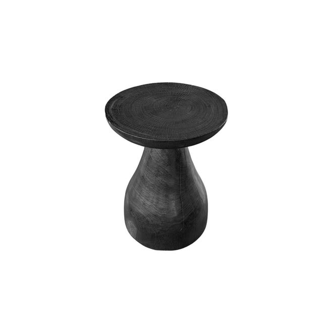 Handcrafted from solid suar wood, this sculptural side table is a celebration of organic form and artisanal craftsmanship....