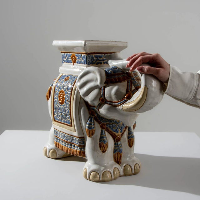 A ceramic decoration from 1960s France in the shape of an elephant. Painted with a white glaze laced with powder blue and...
