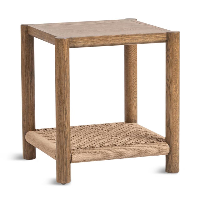 Natural finish oak wood side table with charming woven rope bottom shelf. Stylish contemporary piece with subtle warm...