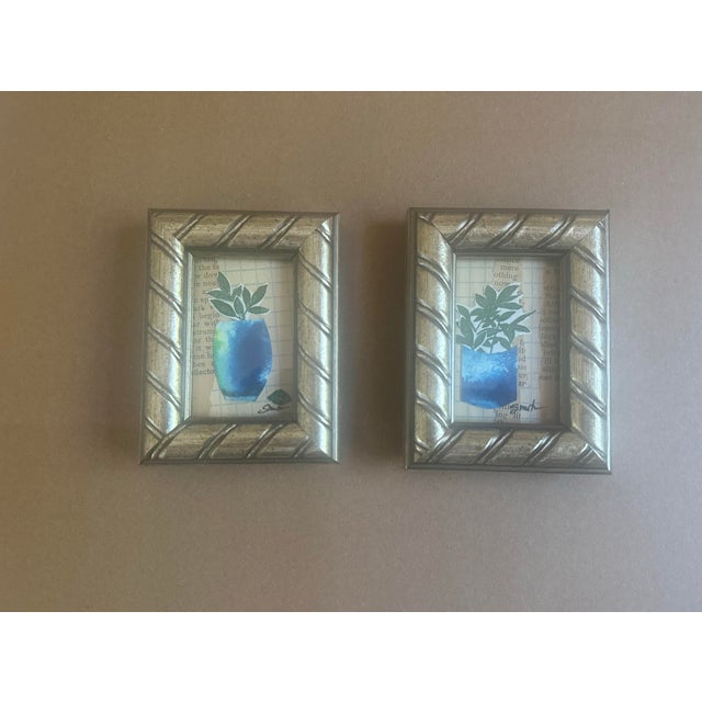 A charming pair of original miniature mixed media collages featuring leafy botanical arrangements in luminous cobalt-blue...
