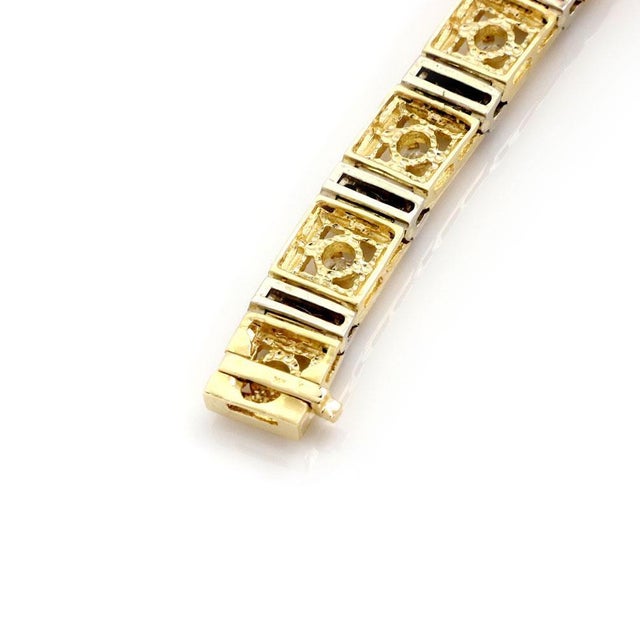 This is a stunning engraved link bracelet, it is crafted from 14k yellow and white gold featurin yellow gold square links...