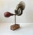 Unusual mounted object in the shape of a antique/1920s brass vehicle horn set on a brass rod and a patinated oak...
