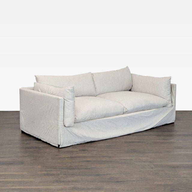 This Four Hands loveseat features a clean, modern design with light slipcover fabric and plush seat and back cushions. Its...