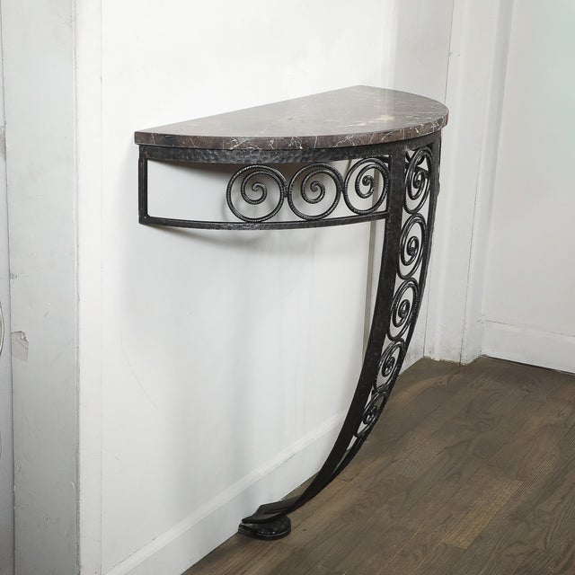 This elegant Art Deco Demilune Wrought-Iron Spiral & Noir St Laurent Marble Console Table originated in France, circa...