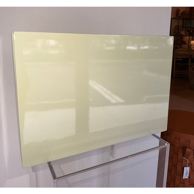 Contemporary decorative box featuring a sleek, high-gloss mint finish accented by warm brass corner feet. Opening to a...