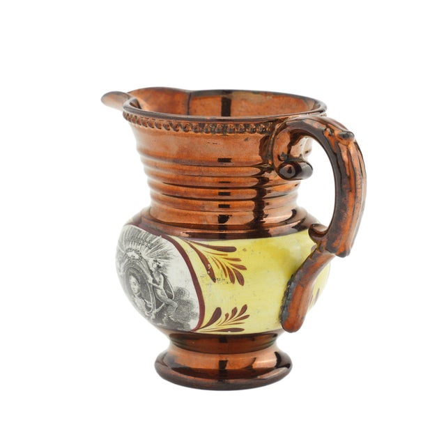 Historic Staffordshire copper luster milk jug made for the American market. The jug features transfer decorations in...