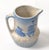 Early 20th Century vintage blue and beige stoneware, earthenware pitcher decorated with a Dutch windmill and tulip motif....