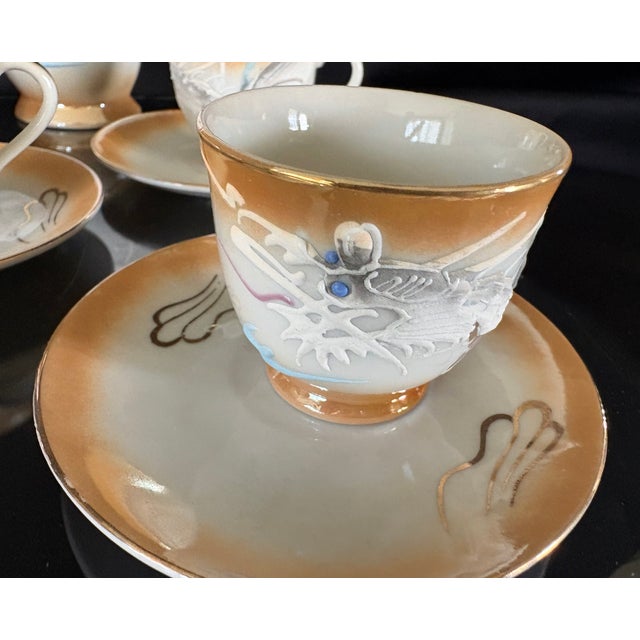 This is a beautiful set of hand painted lusterware. It is a tea set that includes a lidded teapot with six diminutive...