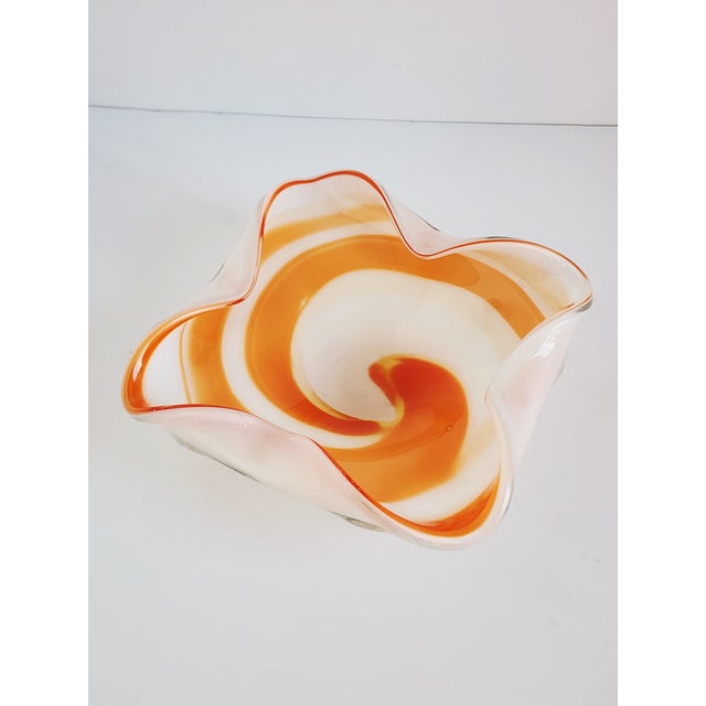 Vintage Mid-Century large Murano glass bowl by Fratelli Toso, featuring a orange and white swirled design. The folded...