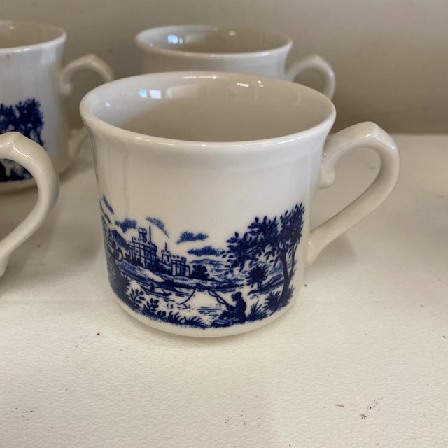 Beautiful set of 4 pastoral Chinoiserie blue and white cups. Perfect for any tablescape.