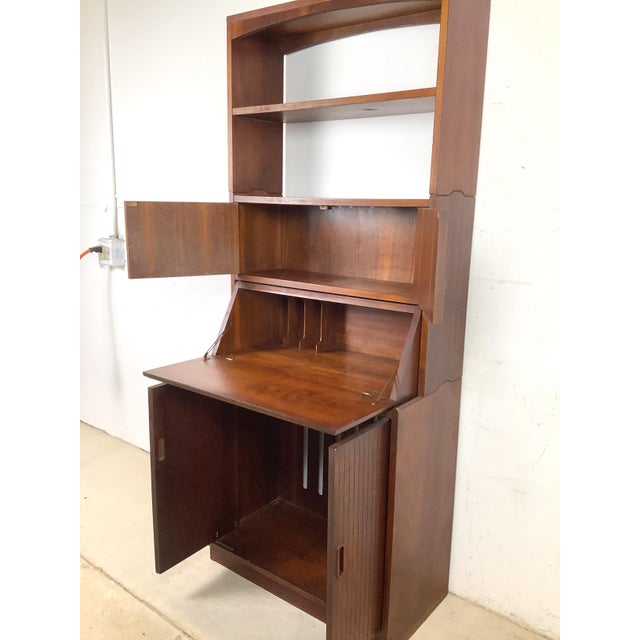 This is the kind of piece that makes a room do more with less — a beautifully designed mid-century modern secretary...