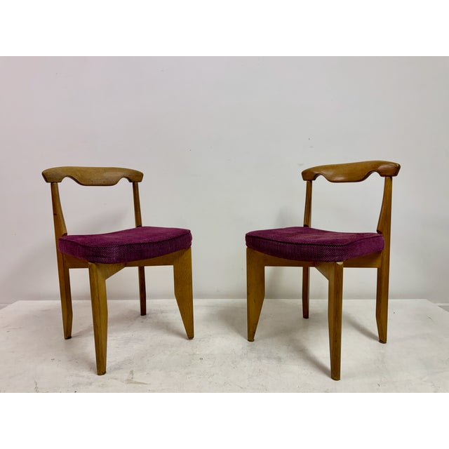 A set of four French dining chairs designed by Guillerme et Chambron for Votre Maison, dating from the 1950s–60s. Crafted...