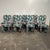 Set of 8 Postmodern dining chairs covered in a vibrant tropical fabric. The chairs feature a curvy silhouette with a...