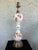 This elegant vintage table lamp dates to the 1970s and features a beautifully shaped milk glass body decorated with a...