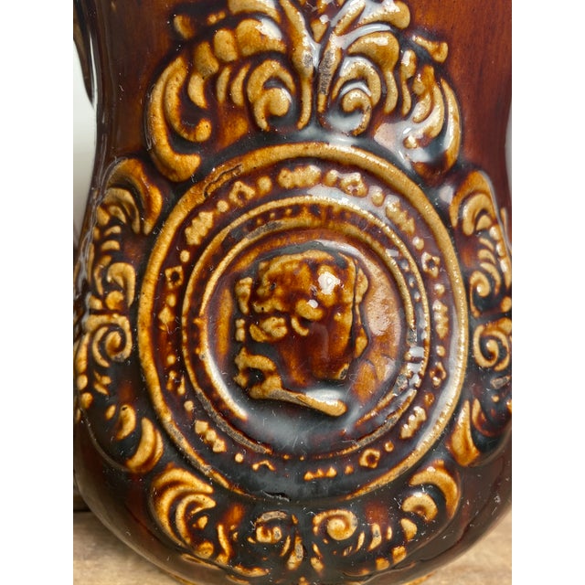 Beautiful brown bennington pitcher with lighter brown details on each side and top of handle.