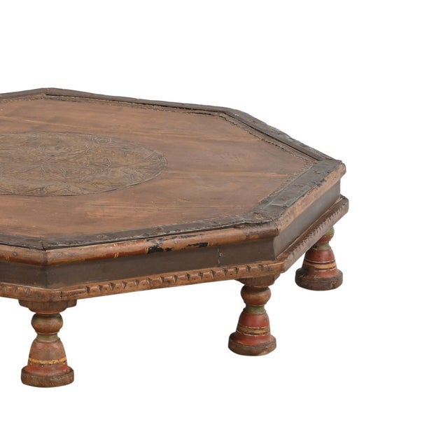Vintage Indian Teakwood Bajot Table, the octagonal top centered with a brass medallion, and a red and yellow painted top...