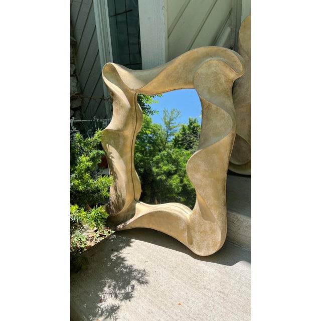 Postmodern sculptural wave shape mirror by David Marshall. Gorgeous carved stone look design with a very dramatic feel....