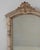 This 1900s French Louis XVI carved oak mirror with shelf features an elegant architectural silhouette and refined...