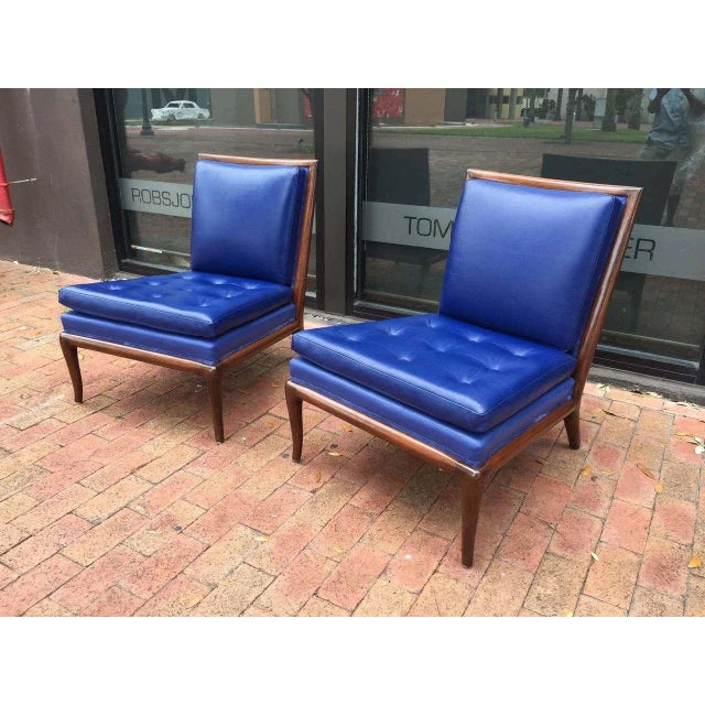 Classic pair of slipper chairs designed by T.H. Robsjohn-Gibbings, circa 1954. The frames are walnut and the chairs have...