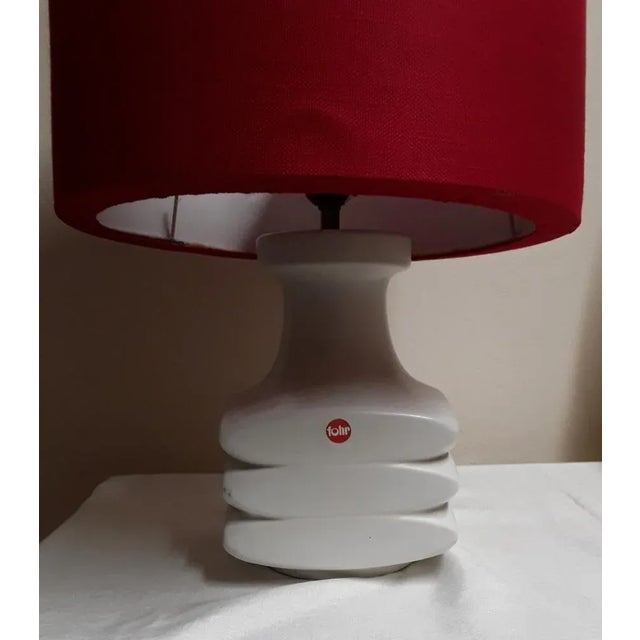 Vintage table lamp from the 70s with a white ceramic base and a red fabric shade by Fohr-Keramik This piece has an...
